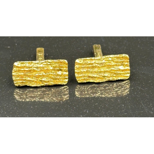 504 - A pair of 9ct gold, cuff links with a bark design, hallmarked for London 1975 and with an approximat... 