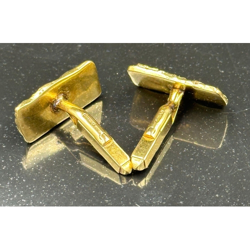 504 - A pair of 9ct gold, cuff links with a bark design, hallmarked for London 1975 and with an approximat... 