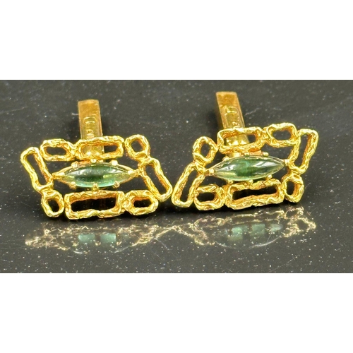 509 - A pair of 18ct gold cuff links with central green stones, hallmarked for London, bearing the makers ... 