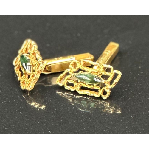 509 - A pair of 18ct gold cuff links with central green stones, hallmarked for London, bearing the makers ... 