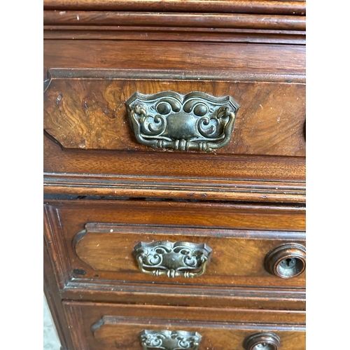 51 - An oak chest of drawers with five standard drawers, a glove drawer and ornate brass drop handles (H1... 