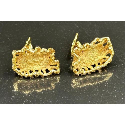 512 - A pair of 9ct gold cuff links with makers mark L'Cise, with interesting molten gold style finish, ap... 