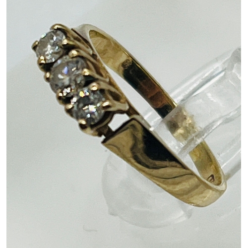 523 - A 9ct gold and three stone diamond ring, marked 375, size J 1/2