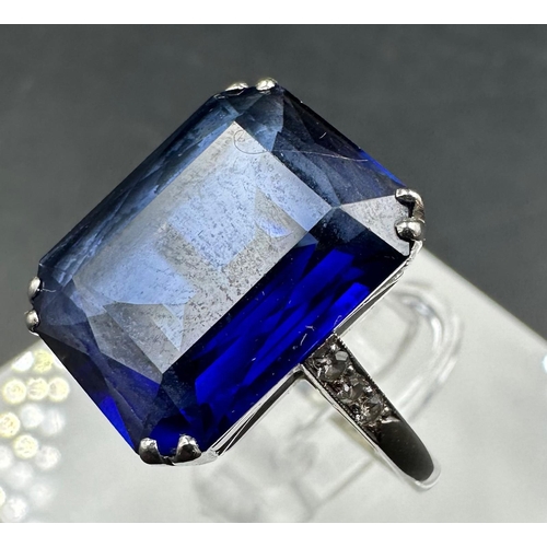 531 - A platinum and 18ct white gold sapphire ring with diamond shoulders. Approximate size M