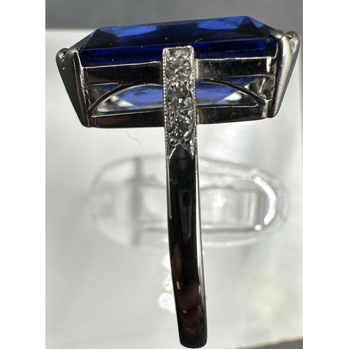 531 - A platinum and 18ct white gold sapphire ring with diamond shoulders. Approximate size M