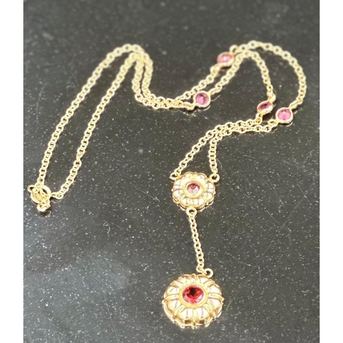 534 - A 14ct gold necklace with garnet pendant and interspaced stones. Approximate total weight 4.5g.