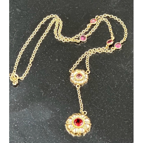 534 - A 14ct gold necklace with garnet pendant and interspaced stones. Approximate total weight 4.5g.