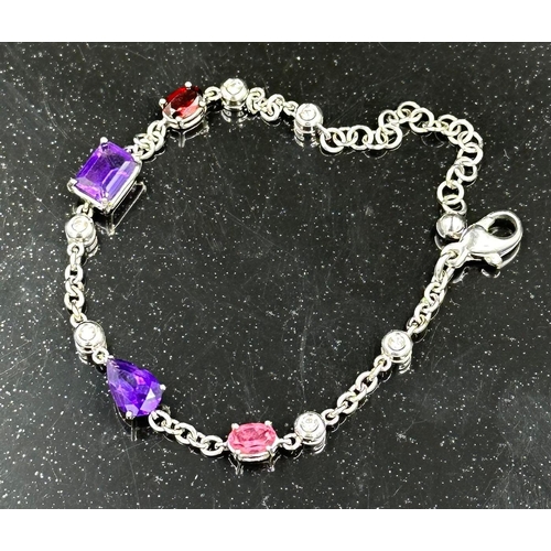 537 - An 18ct white gold bracelet with topaz, amethyst and ruby interspersed by six small diamonds, total ... 