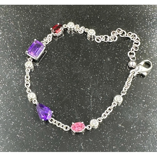 537 - An 18ct white gold bracelet with topaz, amethyst and ruby interspersed by six small diamonds, total ... 