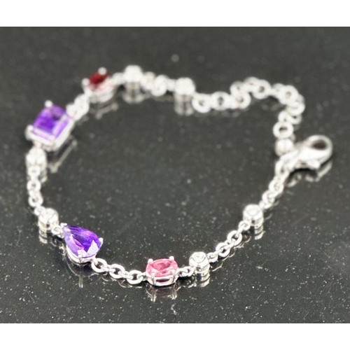 537 - An 18ct white gold bracelet with topaz, amethyst and ruby interspersed by six small diamonds, total ... 