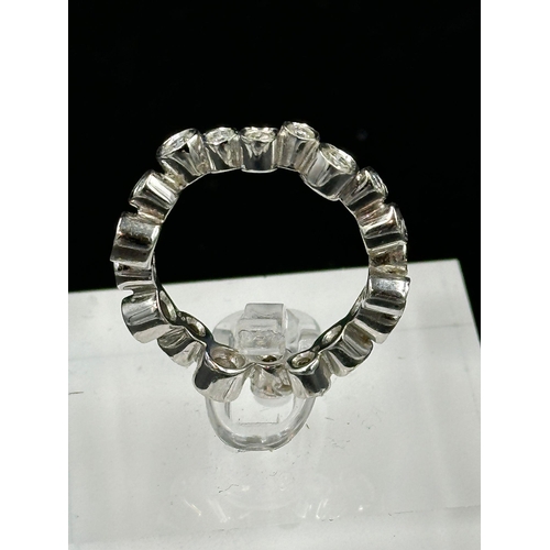 544 - A contemporary take on an eternity ring in 18ct white gold, approximate size N and weight 6.2g