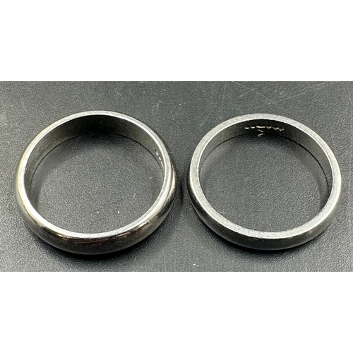 546 - Two platinum wedding bands, approximate total weight 10.6g, and sizes L and M.