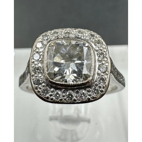 547 - An 18ct white gold diamond ring with central stone of approximately 1.2ct and approximately 0.3ct su... 