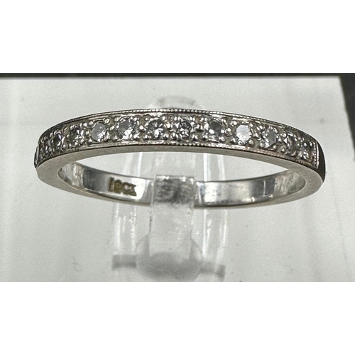 549 - An 18ct white gold wedding band with diamonds, approximately 0.28ct in total, size N