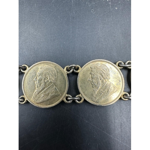 556 - A bracelet of seven 7 South African silver gilt sixpences dated 1897