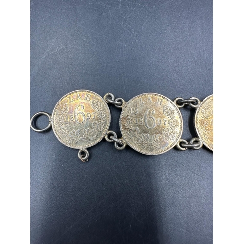 556 - A bracelet of seven 7 South African silver gilt sixpences dated 1897