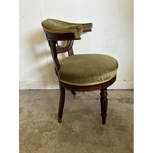 56 - A mahogany framed barrel back wing chair upholstered in green