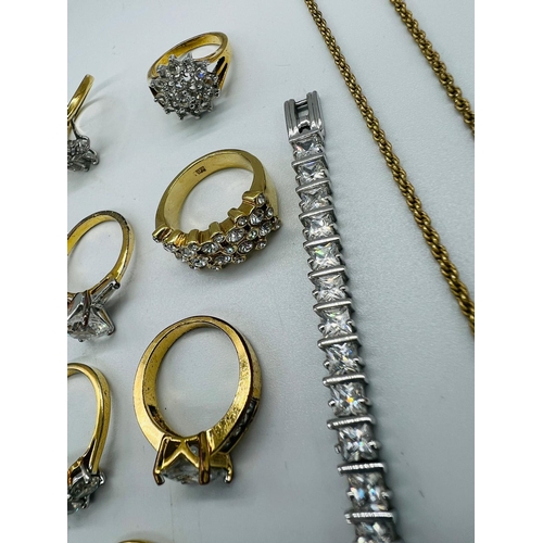 561 - A selection of costume jewellery to include a wide range of white stone fashion rings, a silver line... 