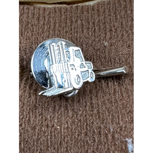 565 - Two forklift truck pin badges, one silver and hallmarked for Birmingham the other 9ct gold marked 37... 