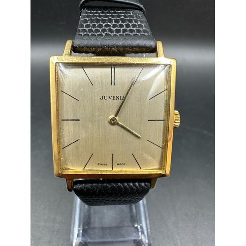 579 - A Juvenia MFG 18ct gold watch on leather strap and in original box.