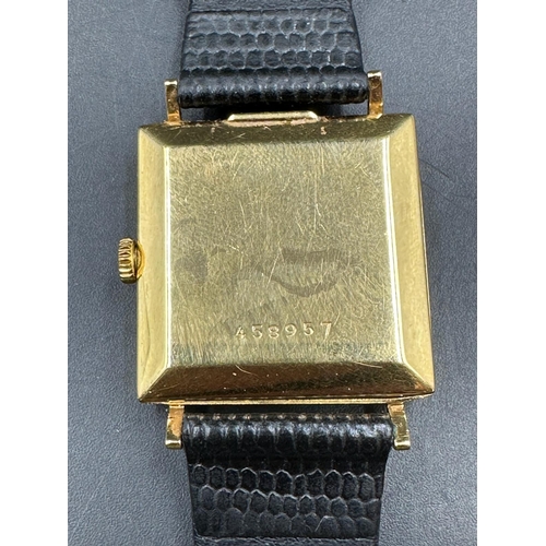 579 - A Juvenia MFG 18ct gold watch on leather strap and in original box.