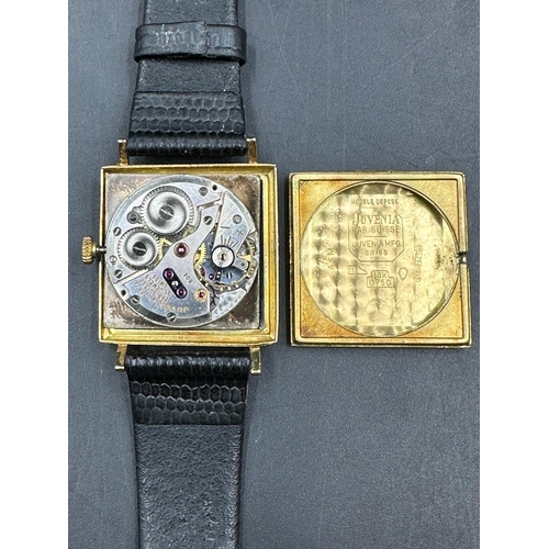 579 - A Juvenia MFG 18ct gold watch on leather strap and in original box.