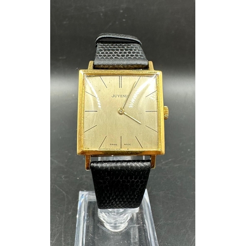 579 - A Juvenia MFG 18ct gold watch on leather strap and in original box.