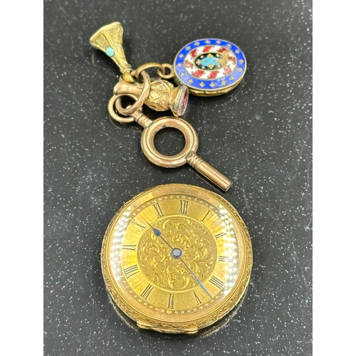 581 - An 18ct gold pocket watch AF along with key, two stamps and and enamel locket