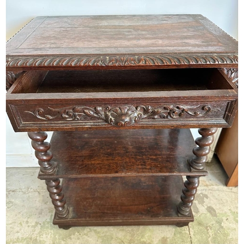 59 - An oak late Victorian buffet, two shelves on barley twist support with a single carved fronted drawe... 