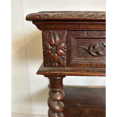 59 - An oak late Victorian buffet, two shelves on barley twist support with a single carved fronted drawe... 