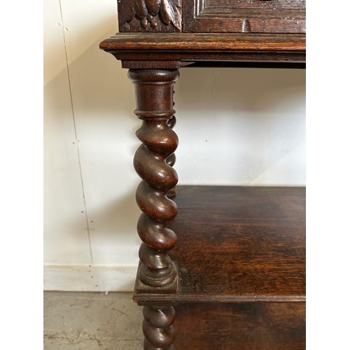 59 - An oak late Victorian buffet, two shelves on barley twist support with a single carved fronted drawe... 