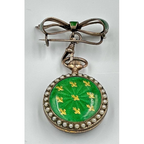 595 - A green enamel and silver pocket watch with Fleur De Lis decoration along with seed peals around the... 