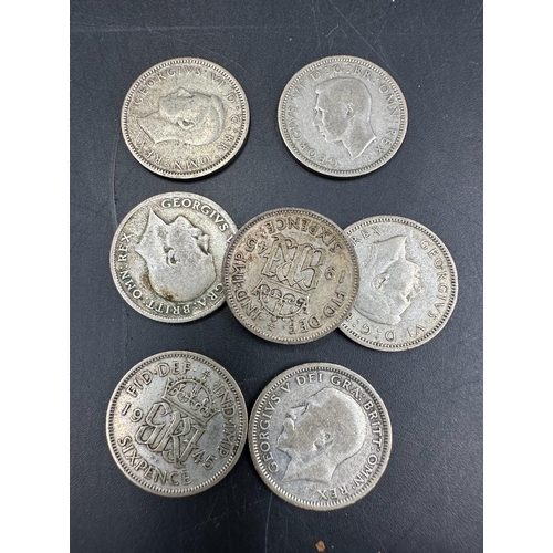 611 - A small selection of Great British coins from Victorian onwards to include three pence coins, sixpen... 