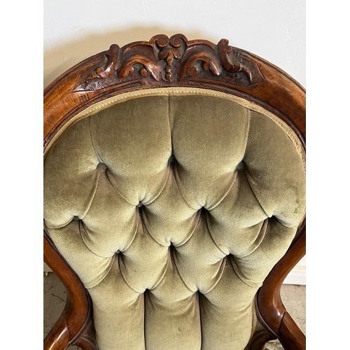 68 - A Victorian open arm chair, spoon button back on cabriole legs