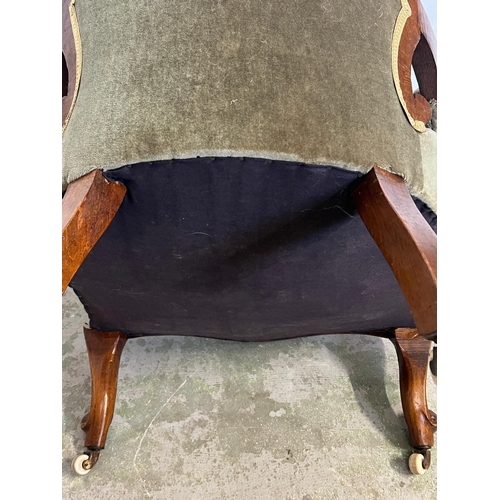 68 - A Victorian open arm chair, spoon button back on cabriole legs