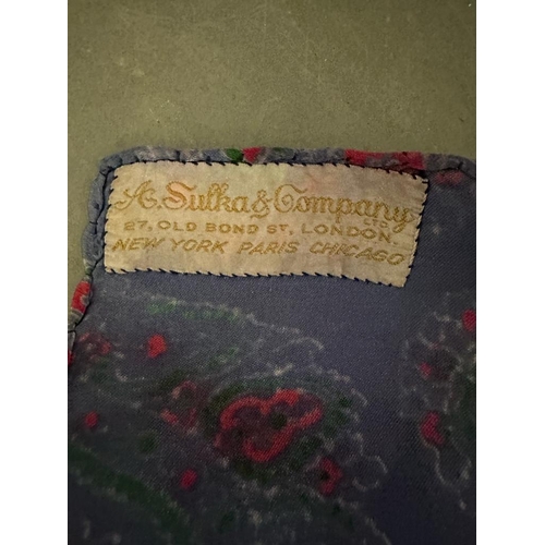 691 - A vintage Sulka and Company of Old Bond street silk scarf in a purple and pink paisley pattern 84cm ... 