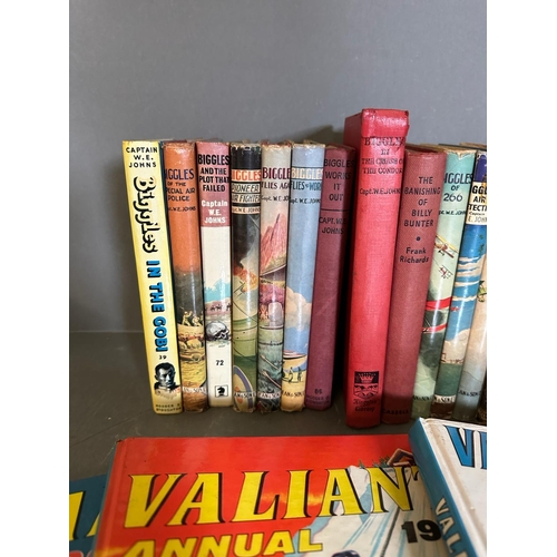 704 - A selection of books and annuals to include Just William, Biggles and Valiand