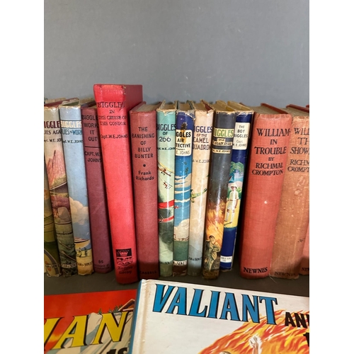 704 - A selection of books and annuals to include Just William, Biggles and Valiand