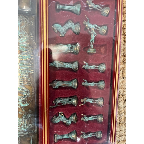 714 - A boxed chess set with bronze effect pieces and metal board