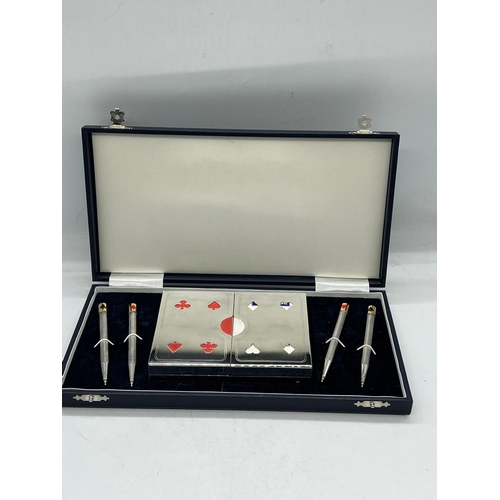 715 - A cased bridge set with pens and cards