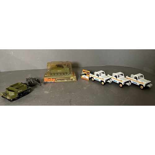 725 - A selection of toy vehicles to include a boxed Dinkey striker anti-tank vehicles and three Britain's... 