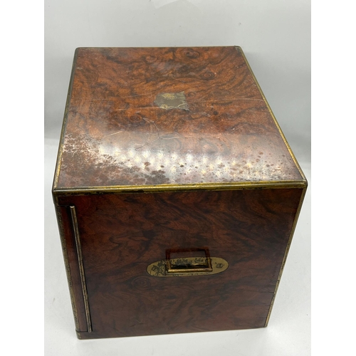 79 - A rosewood campaign style humidor box, the off set doors open to two drawers with adjustable centre ... 