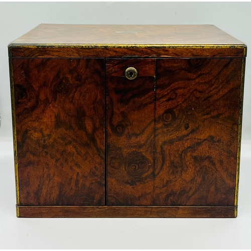 79 - A rosewood campaign style humidor box, the off set doors open to two drawers with adjustable centre ... 