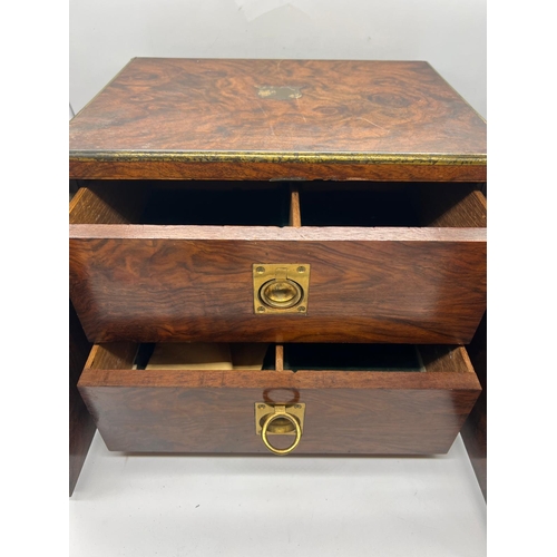 79 - A rosewood campaign style humidor box, the off set doors open to two drawers with adjustable centre ... 