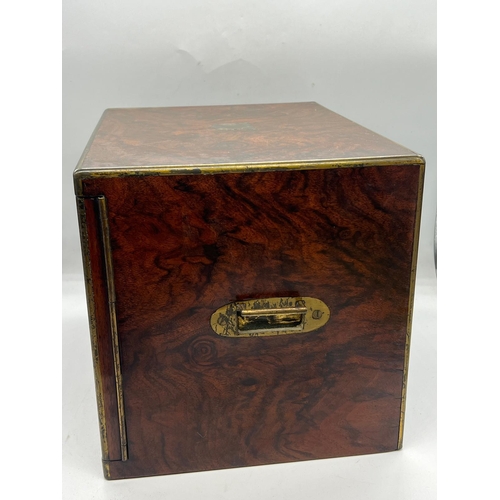 79 - A rosewood campaign style humidor box, the off set doors open to two drawers with adjustable centre ... 