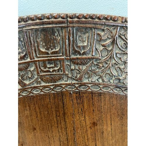 8 - A circular oak table top with carved Indian elephants and temples (Dia122cm)