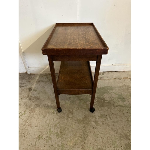 82 - An oak single shelf tea trolley on castors (H74cm E72cm D43cm)