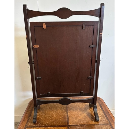 84 - An Art Deco style mahogany fire screen with a peacock and gold detailed front panel on splayed feet ... 