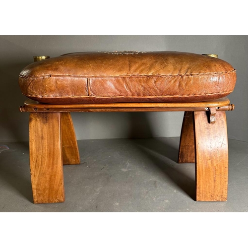 87 - A middle Eastern camel stool with brown leather seat on a hardwood and brass frame