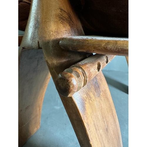 87 - A middle Eastern camel stool with brown leather seat on a hardwood and brass frame